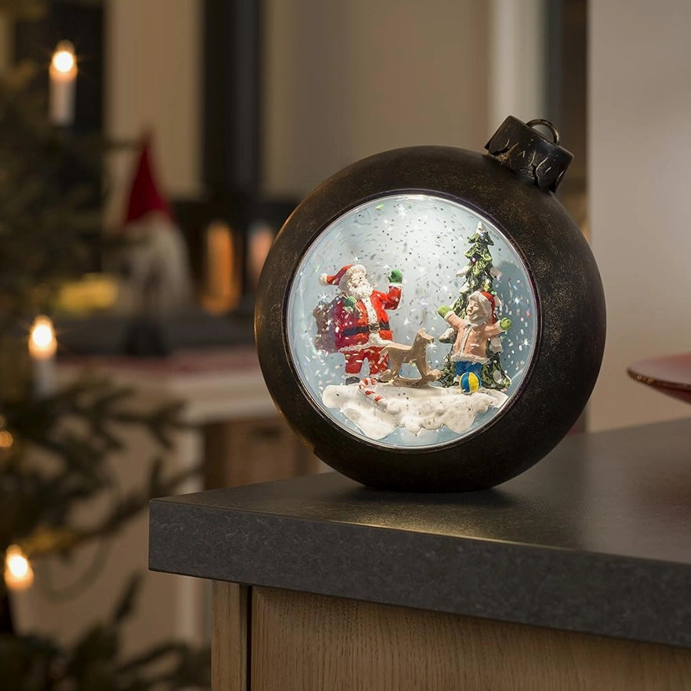 Electric snow globe on table